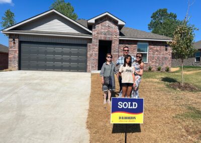 Happy clients in front of their new home in Tulsa