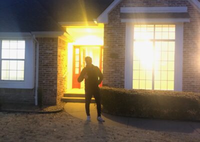 Man standing in front of the house